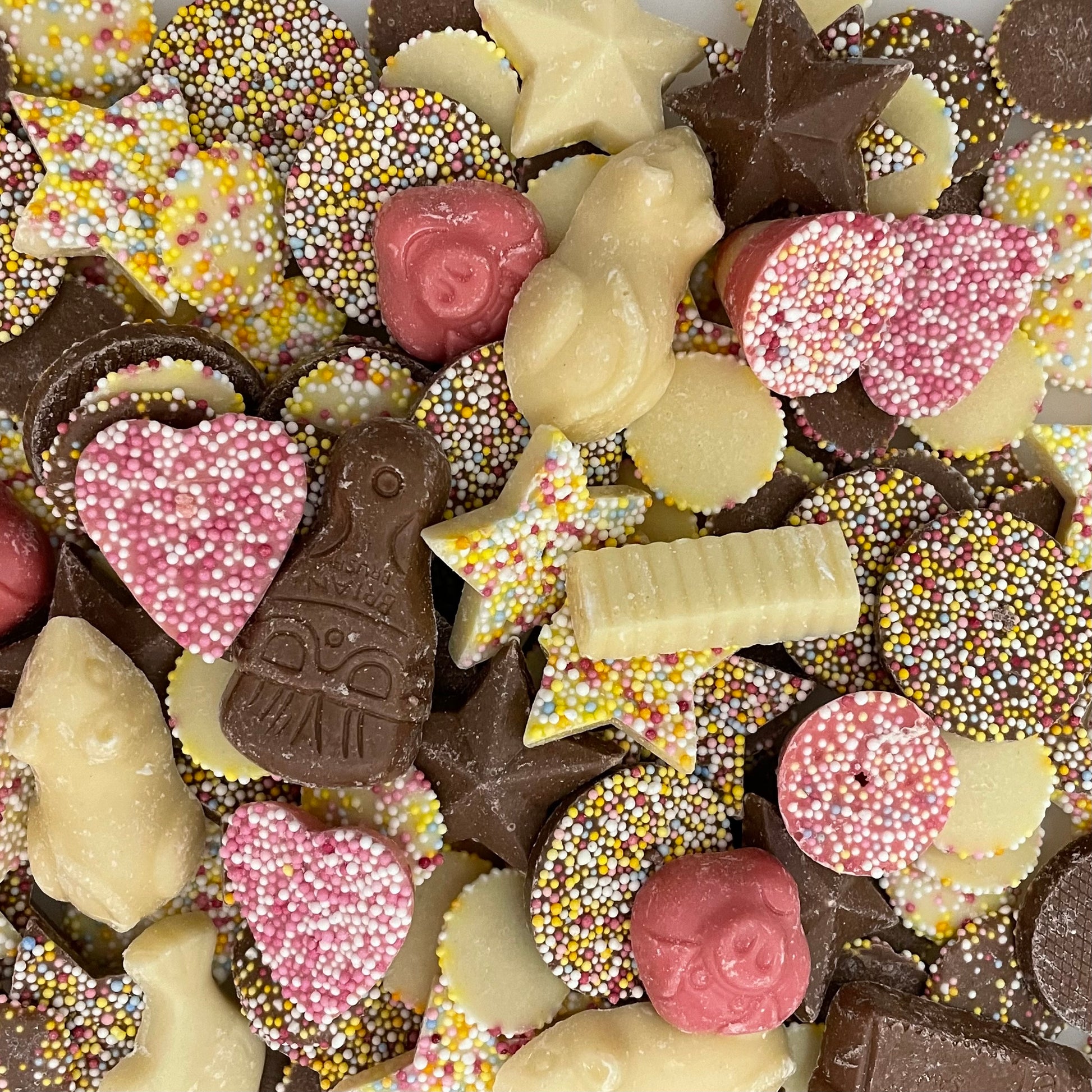 Selection of chocolate-flavoured sweets. Including White Mice, Chocolate tools, Spinning Tops, Fish and Chips, Pink Pigs, Jazzies and more.